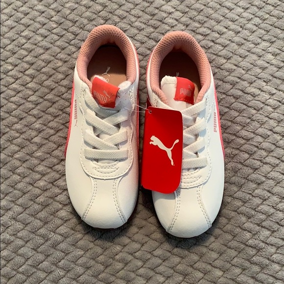 white pumas with pink